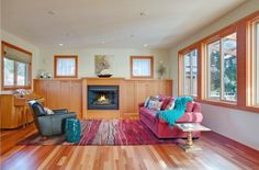 a living room filled with furniture and a fire place in the middle of a room