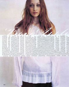 a woman with long hair standing in front of a white background