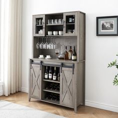 a wooden cabinet with wine glasses and bottles