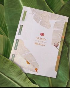 a book sitting on top of a lush green plant