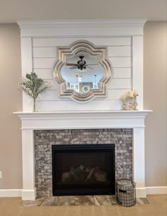 a fireplace with a mirror above it in a living room