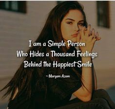 a woman sitting on the ground with her hands clasped to her face, saying i am a simple person who hides a thousand feelings behind the happest smile