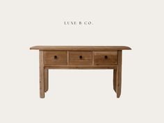 a wooden table with three drawers on one side and the words leave b co above it