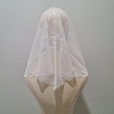 a white veil on top of a mannequin head