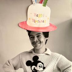 a man wearing a mickey mouse hat with the words happy birthday on it's side