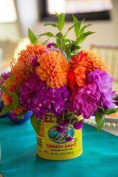 a vase filled with flowers sitting on top of a blue table