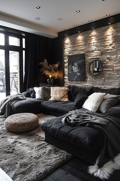 Modern living room with dark sectional sofa, accented by textured stone wall and cozy decor. Modern Chic Living Room Luxury, Aesthetic Black Living Room, Modern Vintage Home Decor Living Room, Gray And Black Interior Design, Modern Design Aesthetic, Living Room Inspiration Black Couch, Black Themed Living Room, Simple Home Decor Living Room, Black Decor Living Room