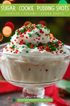 a dessert with white frosting and sprinkles in a glass bowl on a table