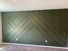 an empty room with green painted walls and carpet