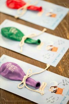 three different colored plastic items tied to each other on top of paper with writing underneath them