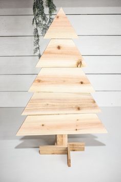 a small wooden christmas tree on a stand