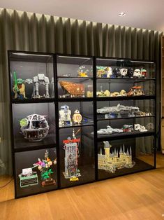 the display case is filled with legos and other toy items, including star wars vehicles