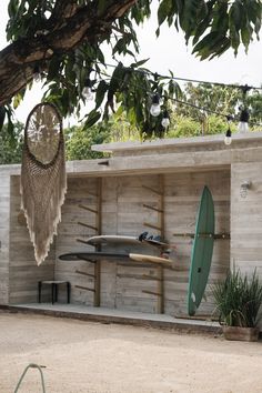 there are two surfboards on display in front of a building with wood sidings