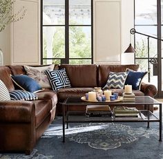 a living room filled with furniture and pillows