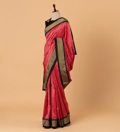 The Red Ikkat Pure Silk Saree is a mesmerizing ode to natural beauty and artistic finesse. Its minute geometric ikkat pattern, delicately woven, evokes the serene majesty of desert landscapes. Enhanced by contrasting black borders, the saree exudes a striking allure, balancing subtlety with vibrancy.  Ready to wear with fall and pico done.  Handmade Designer silk tassels adorn the pallu  SILK MARK CERTIFIED Blouse - Unstitched SAREE Craft : HandWoven Pattern : All over Purity : Pure Saree Color :  Red Saree Fabric : Ikkat Silk Saree length : 5.5 Mtrs Saree Work : Woven BORDER/PALLU Saree Border Color : Black Saree Border Fabric :Silk Saree Border Work :Woven BLOUSE Saree Blouse Border : GOLD Blouse Border Work :Woven Blouse Fabric :Silk / 80cm Blouse Length :80 cm Blouse pattern :Unstitche Elegant Handloom Red Pre-draped Saree, Elegant Red Handloom Pre-draped Saree, Traditional Ikat Print Dupatta Designer Wear, Traditional Ikat Print Dupatta For Designer Wear, Red Handloom Pre-draped Saree For Transitional Season, Red Ikat Print Saree With Traditional Drape, Red Handloom Raw Silk Pre-draped Saree, Red Ikat Print Traditional Wear, Traditional Red Ikat Print Wear