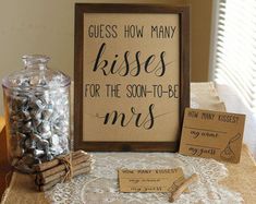 there is a sign that says guess how many kisses for the son - to - be