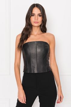 Soft yet structured, this leather bustier is an unexpectedly chic layer under blazers and jackets. A straight neck offers a classic look up top, while stretch lining offers comfortable movement all around. Black Structured bustier Straight neckline Zipper at center back Stretch lining for added comfort Supple, 100% Lamb Leather Lining, 100% Polyester FIT FITTED: Garment fits close to the body. If in between sizes or looking to layer, we recommend sizing up. Jessica is 5'9", has a 24" waist, and Leather Bustier, Back Stretches, Leather Corset, Straight Neckline, Classic Looks, Strapless Top, Black Leather, Blazer, Women's Top