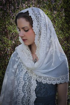 A veil in honor of Our Lady of Guadalupe. An incredibly soft veil. This is a lovely and soft fabric, strewn with lovely embroidered flowers. The delicate flowers are scattered over the entire veil, and the edge is scalloped gently around the face. Finished with an intricate Venice trim at the hem. Wrap it in several ways, or wear it down, and as a shawl. This generously-sized tapered rectangle veil measures about 70 x 24 inches. Evintage veils are handmade in limited production; not mass produce Elegant Wedding Dupatta With Lace Trim, Elegant White Dupatta For Marriage, Elegant Dupatta For Wedding, Elegant Dupatta For Marriage, White Bohemian Wedding Dupatta, White Bohemian Dupatta For Wedding, Bohemian White Dupatta For Wedding, Cream Lace Wedding Veil, Vintage Lace Wedding Veil