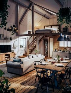 a living room filled with furniture next to a kitchen and dining table in front of a loft