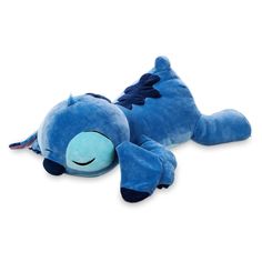 a blue stuffed animal laying on its side