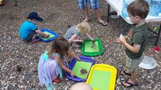 children playing with sand and water at an outdoor event