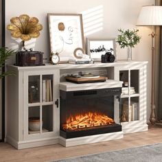 a living room with a fire place in the center and pictures on the wall next to it