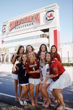 a group of young women standing next to each other in front of a sports store