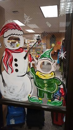 a frosty glass window with a snowman and santa clause on it