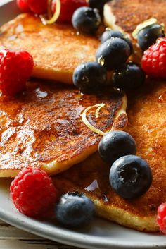 pancakes with berries and syrup on a plate