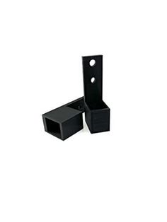 two black plastic boxes with holes in the middle and one is empty, on a white background