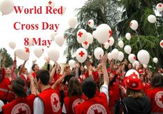 a group of people in red shirts and white balloons with the words world red cross day 8 may