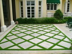 an outdoor patio with grass on the ground