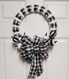 a black and white wreath hanging on the front door