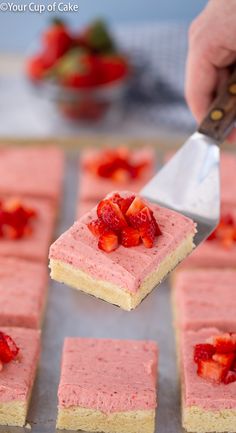 there is a piece of cake with strawberries on it being held by a fork