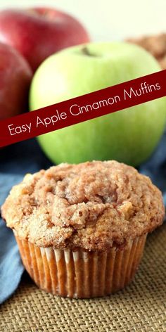 an apple cinnamon muffin next to some apples on a burlap tablecloth