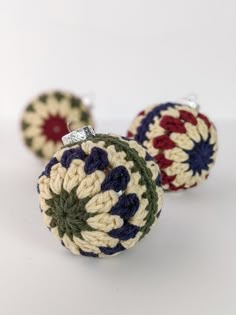 two crocheted ornaments sitting on top of each other