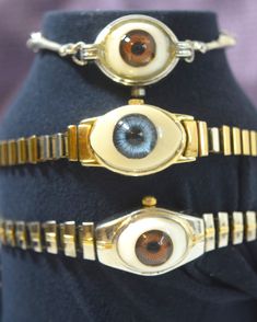 "Unique altered -\"Eye Candy\" watch bracelet created from repurposed vintage doll eyes and vintage watch bands and bracelets.  This is not a watch but a great eye opener and conversation starter.   No two are alike choose your style and color in the drop down box.  Eyes are adhered to the empty watch casing and sealed with a polymer to protect the eye.  Style and length of bands vary-please measure your wrist or ankle for sizing.  Gold tone expandable band with blue eye fits 5-8 inch wrist. Sil Candy Watch, Candy Bracelet, Old Watches, Repurposed Vintage, Watch Bracelet, Doll Eyes, Blue Eye, Vintage Doll, Women Wrist Watch