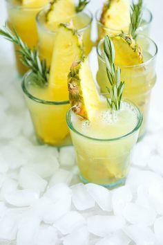 pineapple and rosemary garnish in glasses on ice