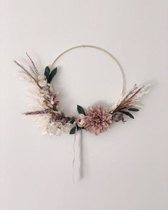 a flower wreath is hanging on the wall