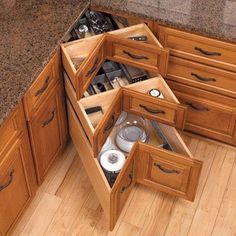 an open drawer in the corner of a kitchen