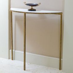 a console table with a bowl on top