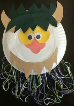 a paper plate with an image of a monster on it's face and green hair