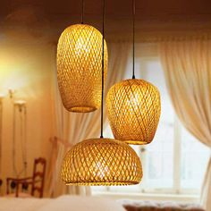 three lights hanging from the ceiling in a bedroom