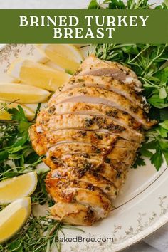 sliced turkey breast on a plate with lemons and herbs