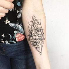 a woman's arm with a rose and triangle tattoo on the left inner arm