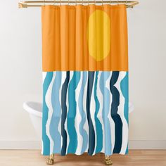 a shower curtain with an orange sun and blue wavy lines on the bottom, in front of a white bath tub