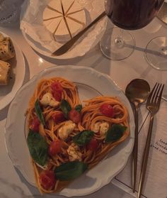 a heart shaped pasta dish on a white plate