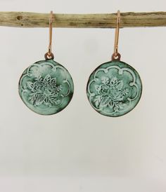 18mm circle discs with a border and flower stamp design. Layers of enamel have been applied to pick out the design.  The ear wires are rose gold plated. The final colour is a pale jade and white colour. Round Enamel Earrings, Green Enamel Hoop Earrings, Single Green Enamel Earring, Vintage Round Enamel Earrings, Green Artisan Enamel Earrings, Flower Texture, Vitreous Enamel, Drop Dangle Earrings, Flower Stamp