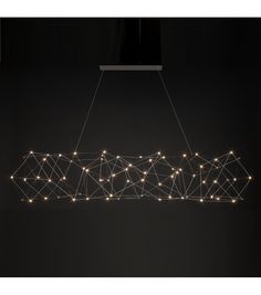 a light fixture hanging from the ceiling in a dark room with string lights on it