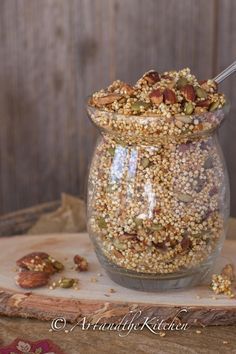 a jar filled with granola sitting on top of a wooden table